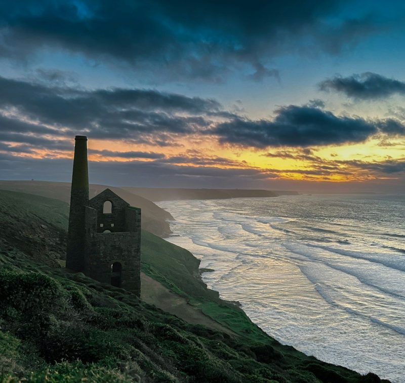 a tower on a hill overlooking the ocean